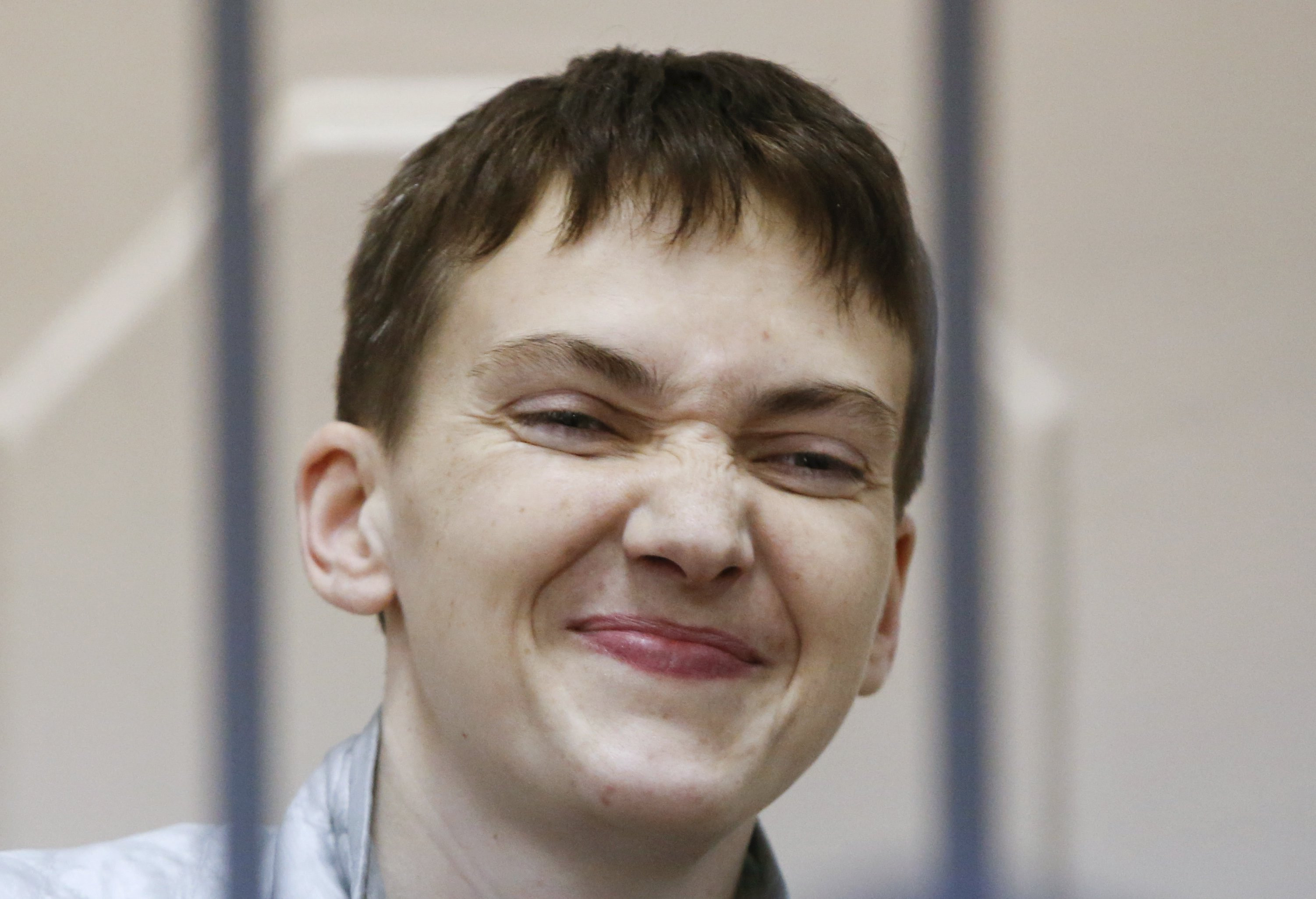 Ukrainian military pilot Nadezhda Savchenko reacts inside a defendant's cage during a court hearing in Moscow