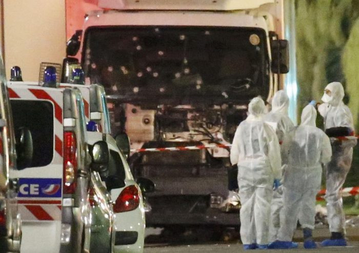 French police forces and forensic officers stand next to a truck July 15, 2016 that ran into a crowd celebrating the Bastille Day national holiday on the Promenade des Anglais killing at least 60 people in Nice, France, July 14. REUTERS/Eric Gaillard