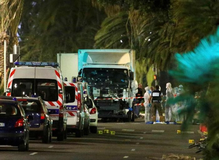 French police forces and forensic officers stand next to a truck July 15, 2016 that ran into a crowd celebrating the Bastille Day national holiday on the Promenade des Anglais killing at least 60 people in Nice, France, July 14. REUTERS/Eric Gaillard