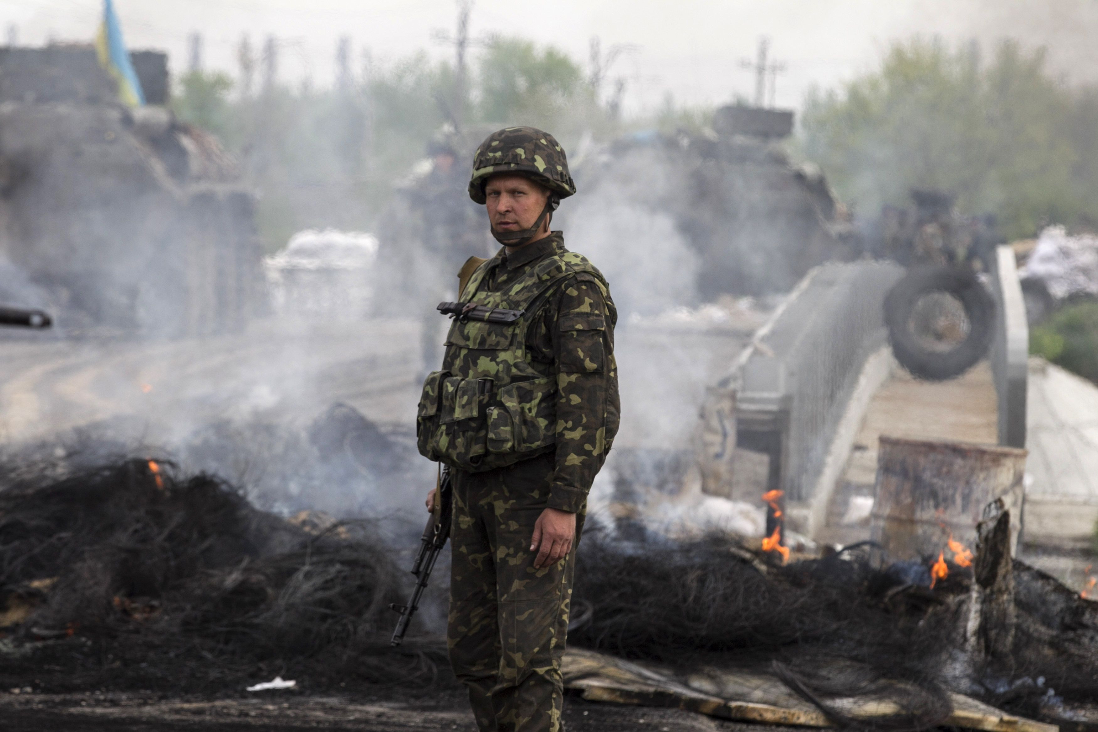 A Ukrainian soldier looks on at a Ukrainian checkpoint near the eastern town of Slaviansk