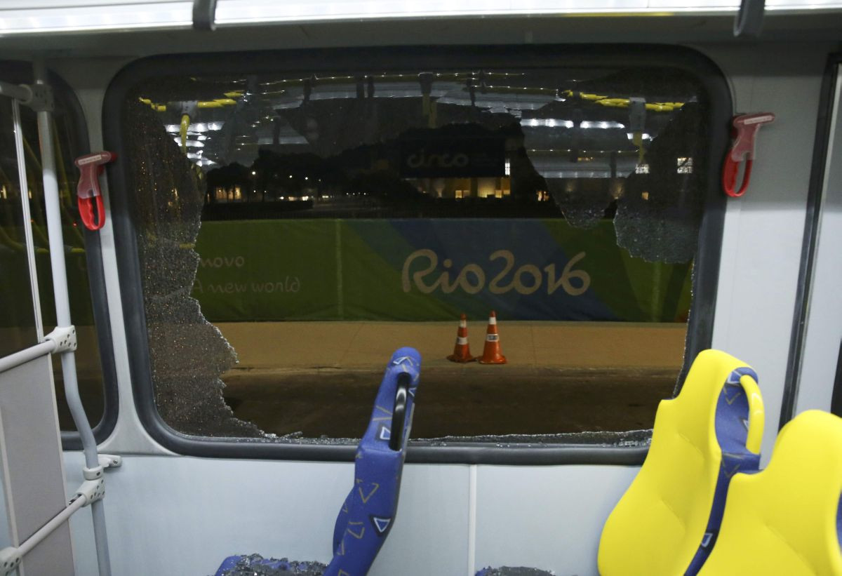 A broken window on an official media bus after it shattered in Rio de Janeiro