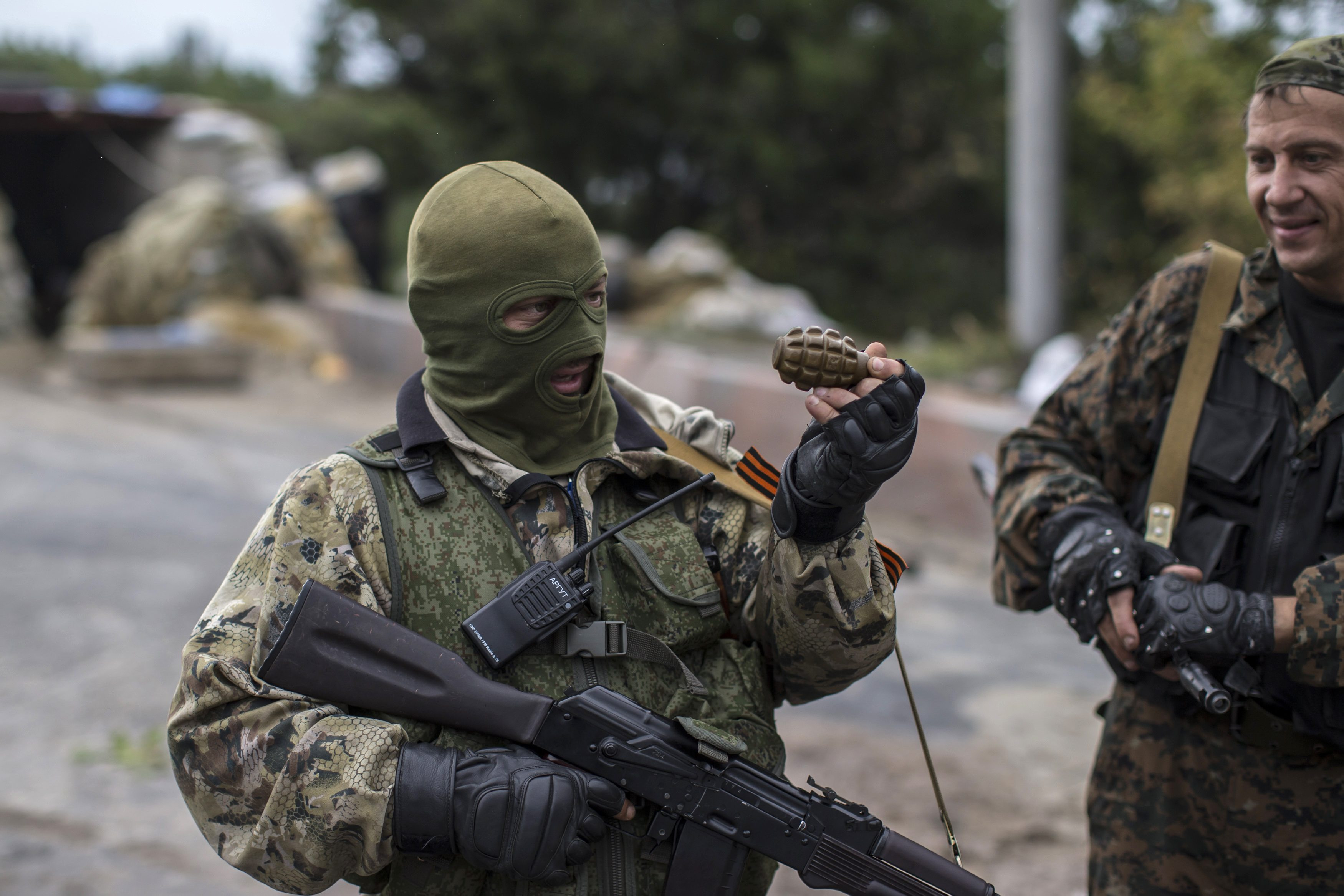 A Pro-Russian rebel holds a hand grenade at a checkpoint near the airport in Donets