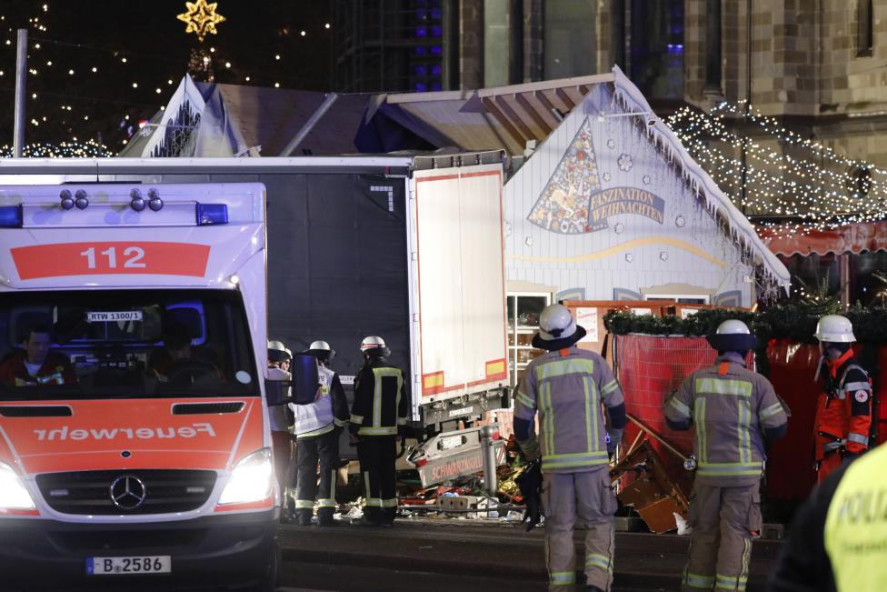 Firefighter stand beside a truck at a Christmas market in Berlin