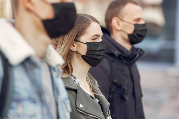 people-in-a-masks-stands-on-the-street_1157-31567