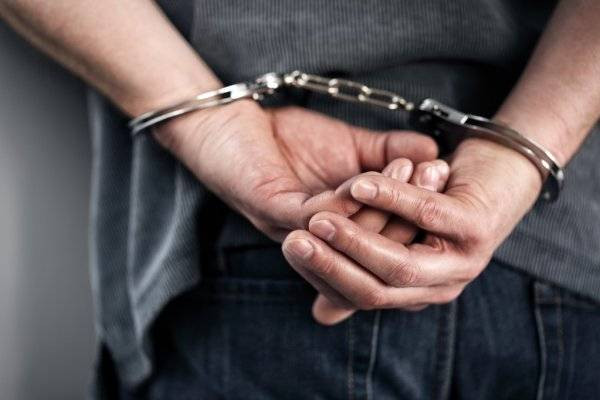 depositphotos_70908647-stock-photo-arrested-man-in-handcuffs